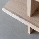 Close-up view of storage Oak Bookcase live edge shelf, finished in Cornsilk colour