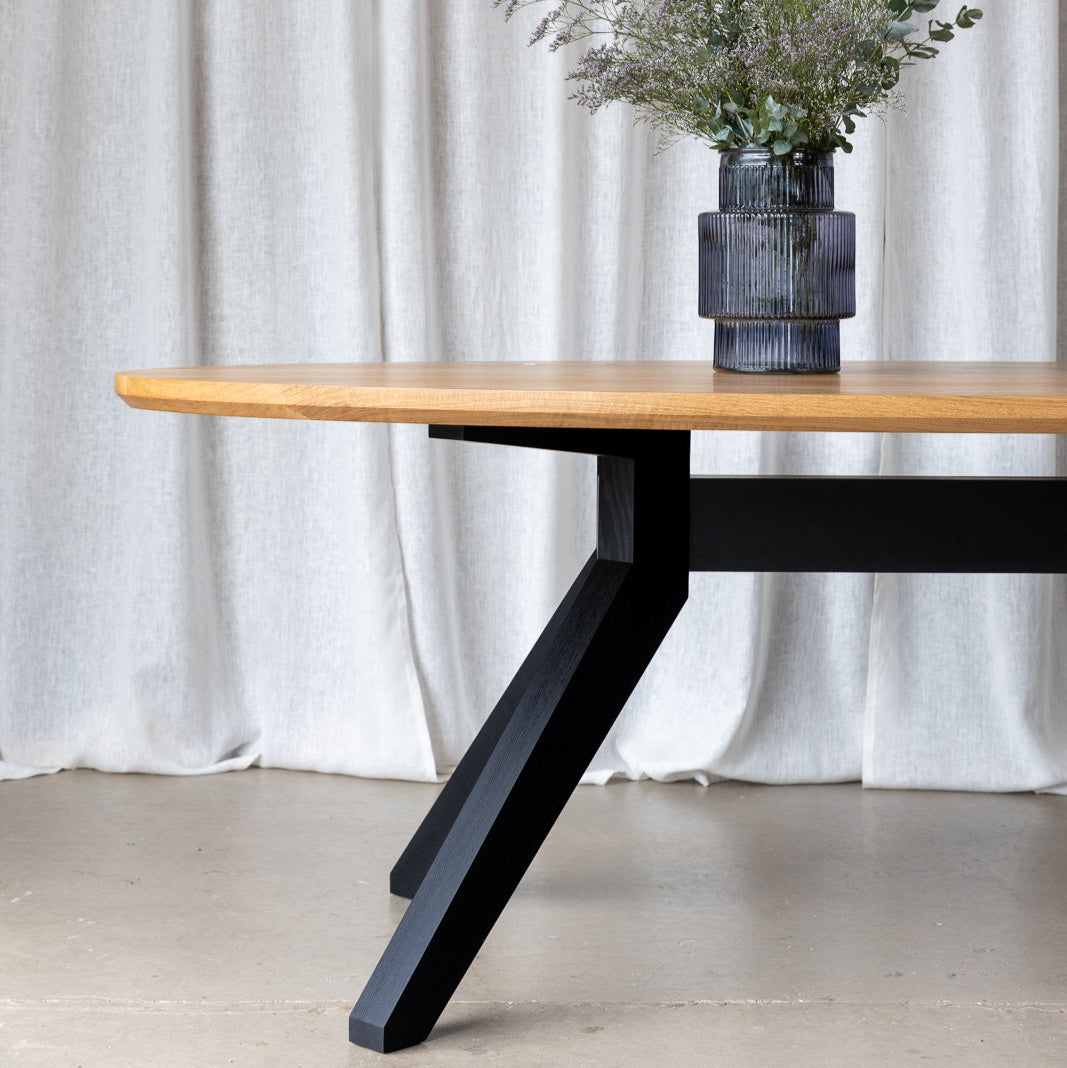 Close-up image showcasing the exquisite details of the oval dining table, capturing its elegant curves and fine craftsmanship, inviting gatherings and conversation.