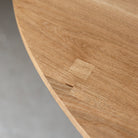 Close-up image highlighting the intricate hand-chiselled wooden blockings adorning the table's top, meticulously preserving the natural cracks and blemishes of the timber, enhancing its organic beauty and unique character.