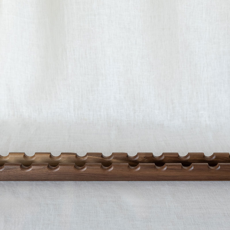 long and narrow canapé serving platter in walnut wood for 12 oval-shaped nibbles.