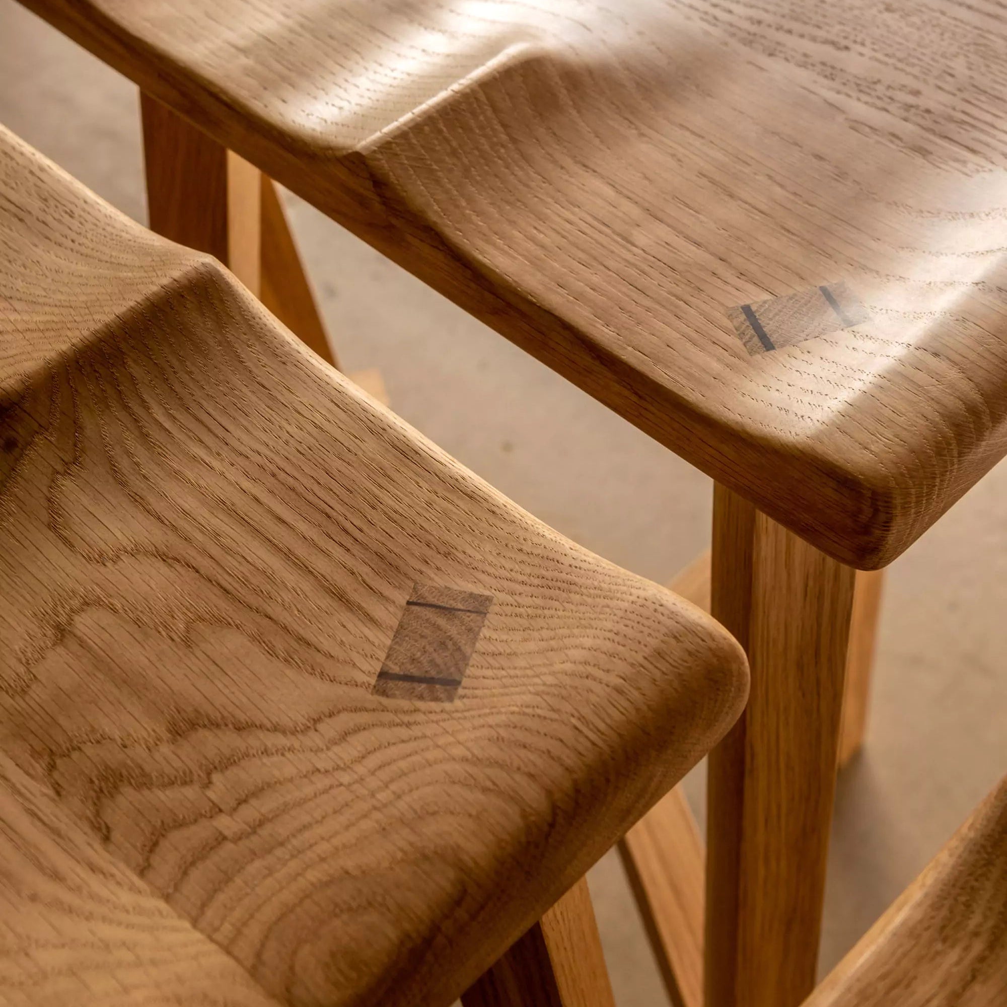 Wooden Oak stools with a soft light  on a neutral background