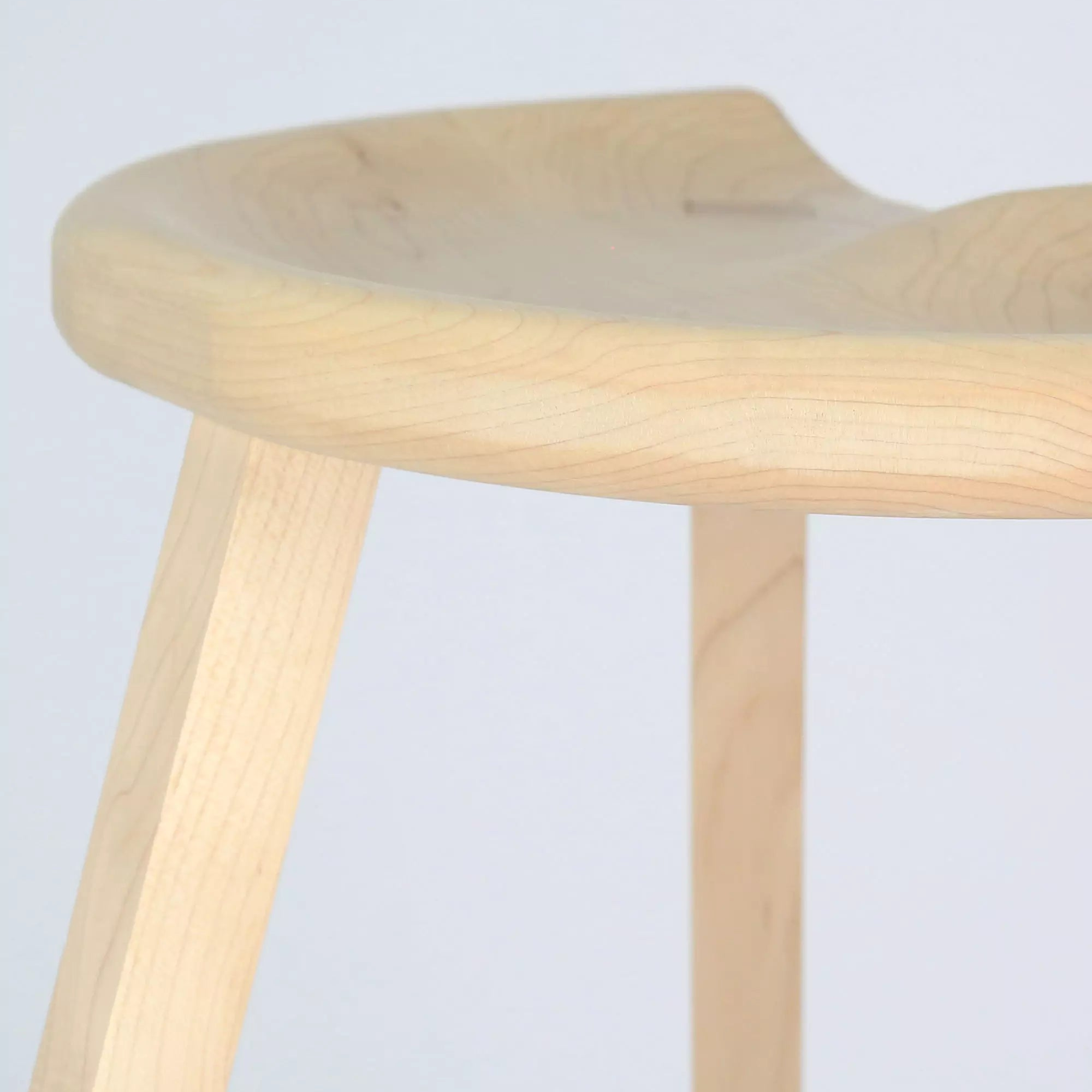Maple stool with a light finish on a white background