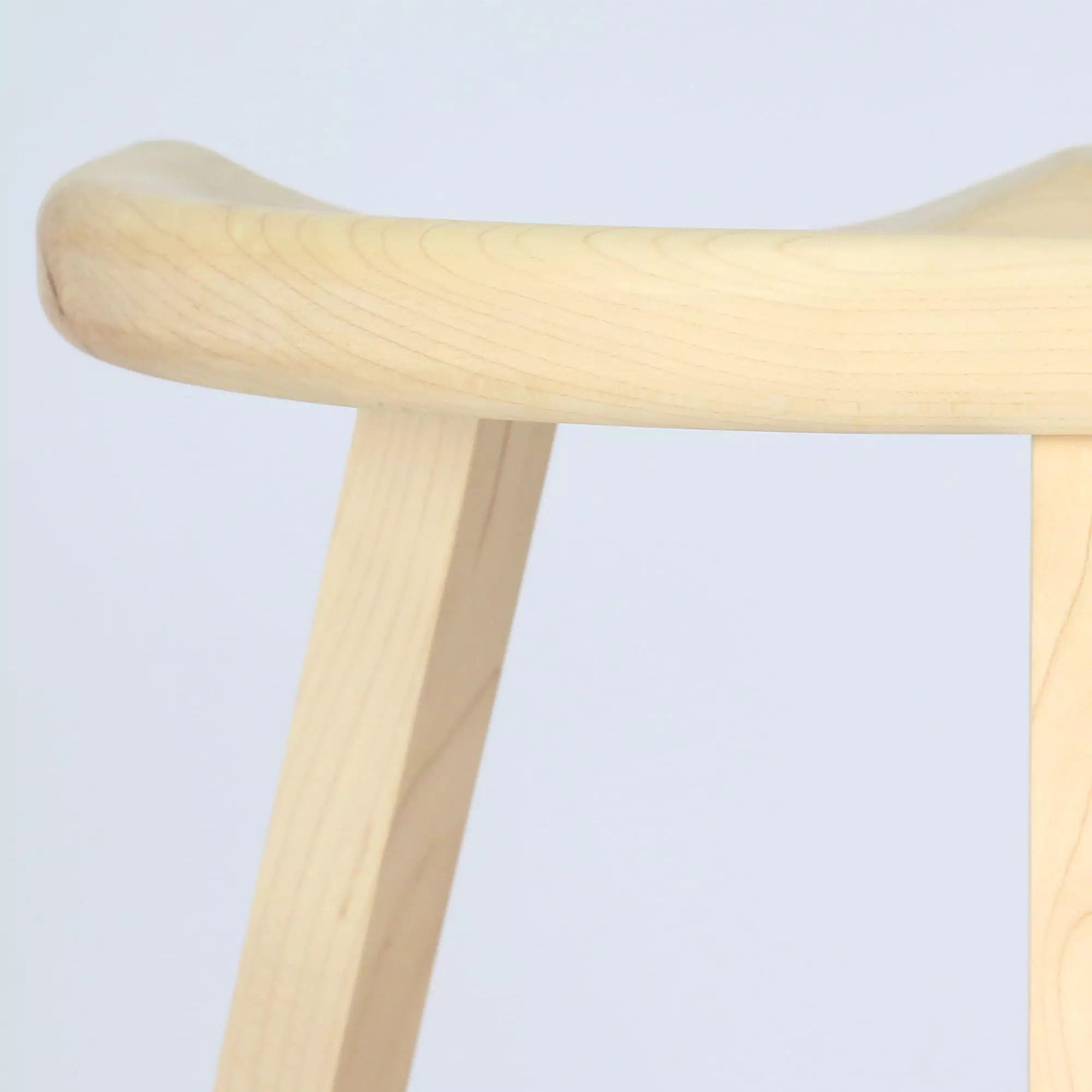 Maple stool close-up with a light finish on a light grey background