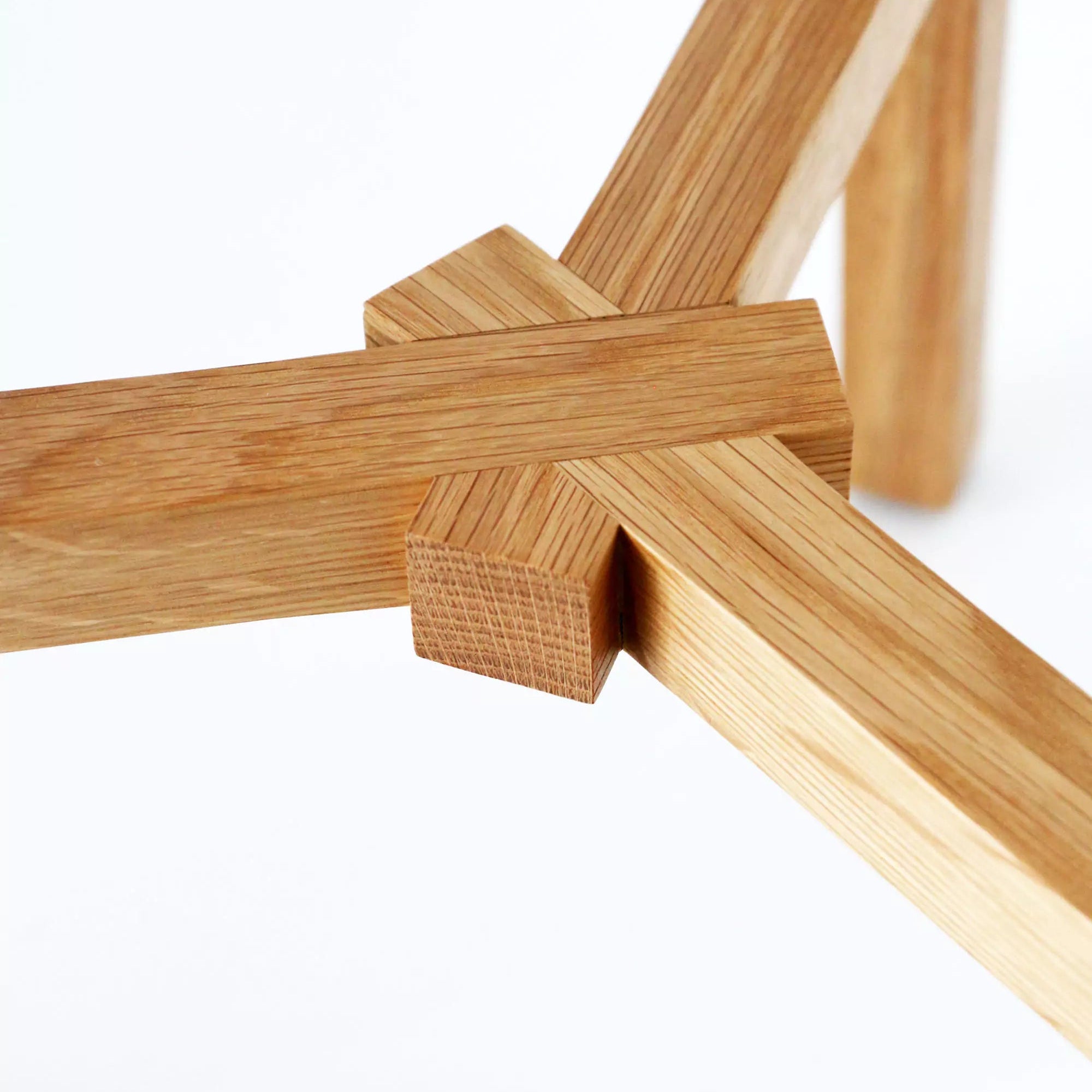 Close-up of a wooden stool frame on a white background