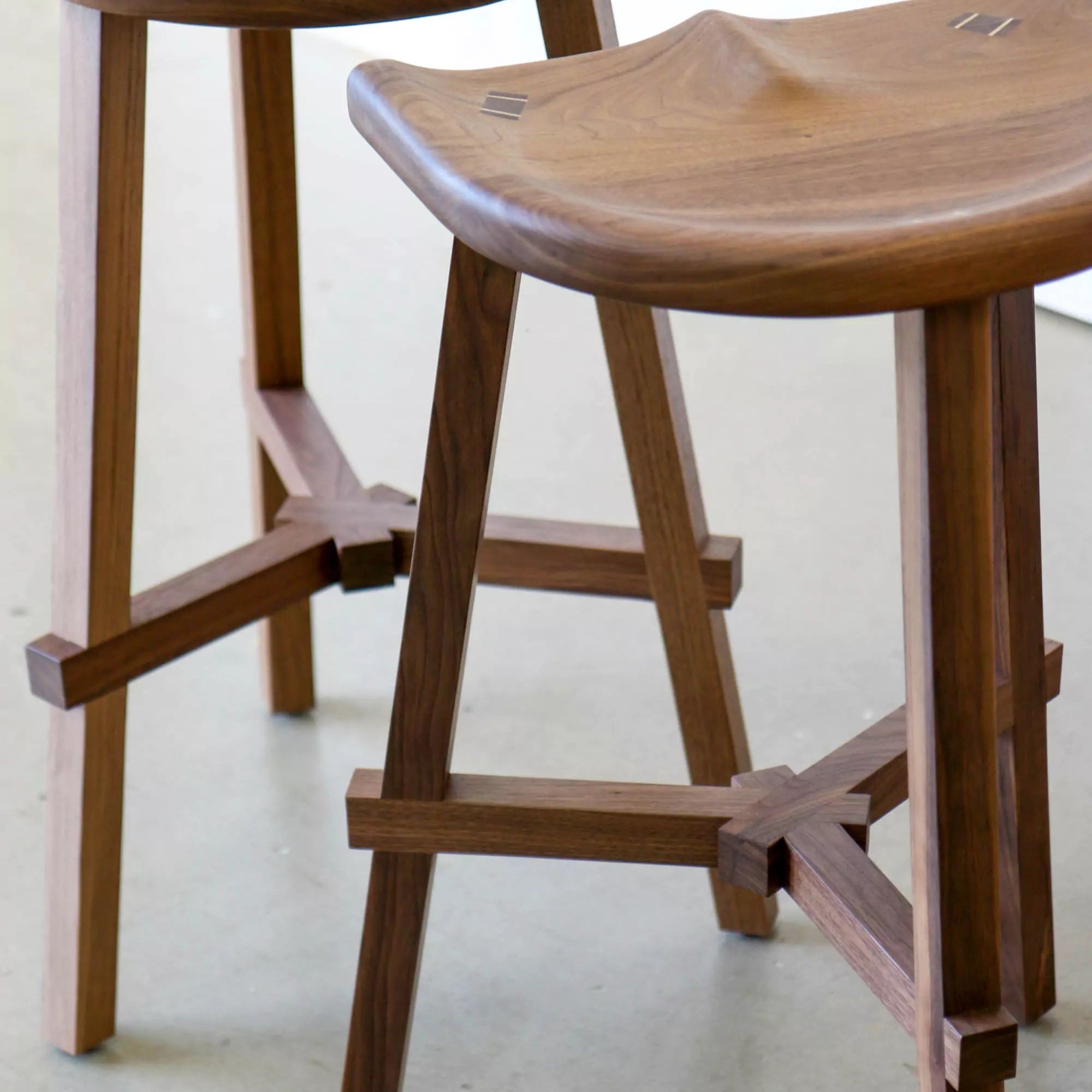 Wooden stools with a minimalist design on a light background