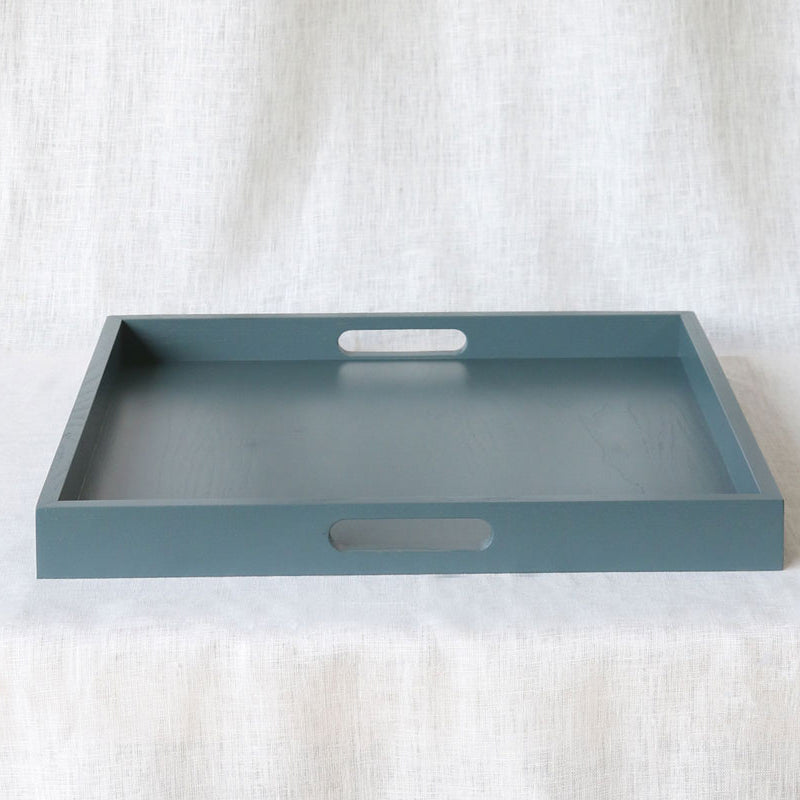 Front-facing image of the tray highlighting clean edges and dual handles against a soft white background.