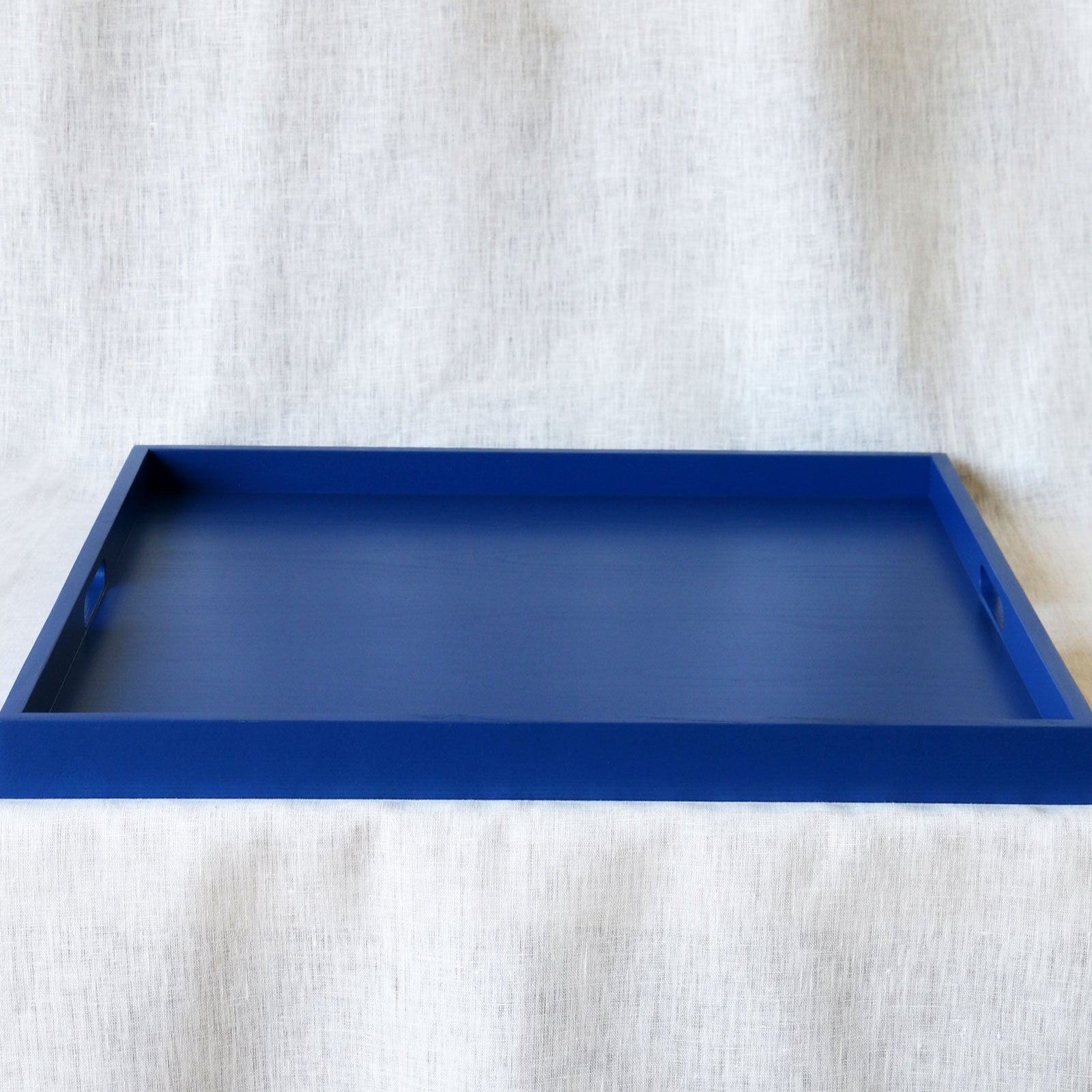 Blue tray on a textured white surface