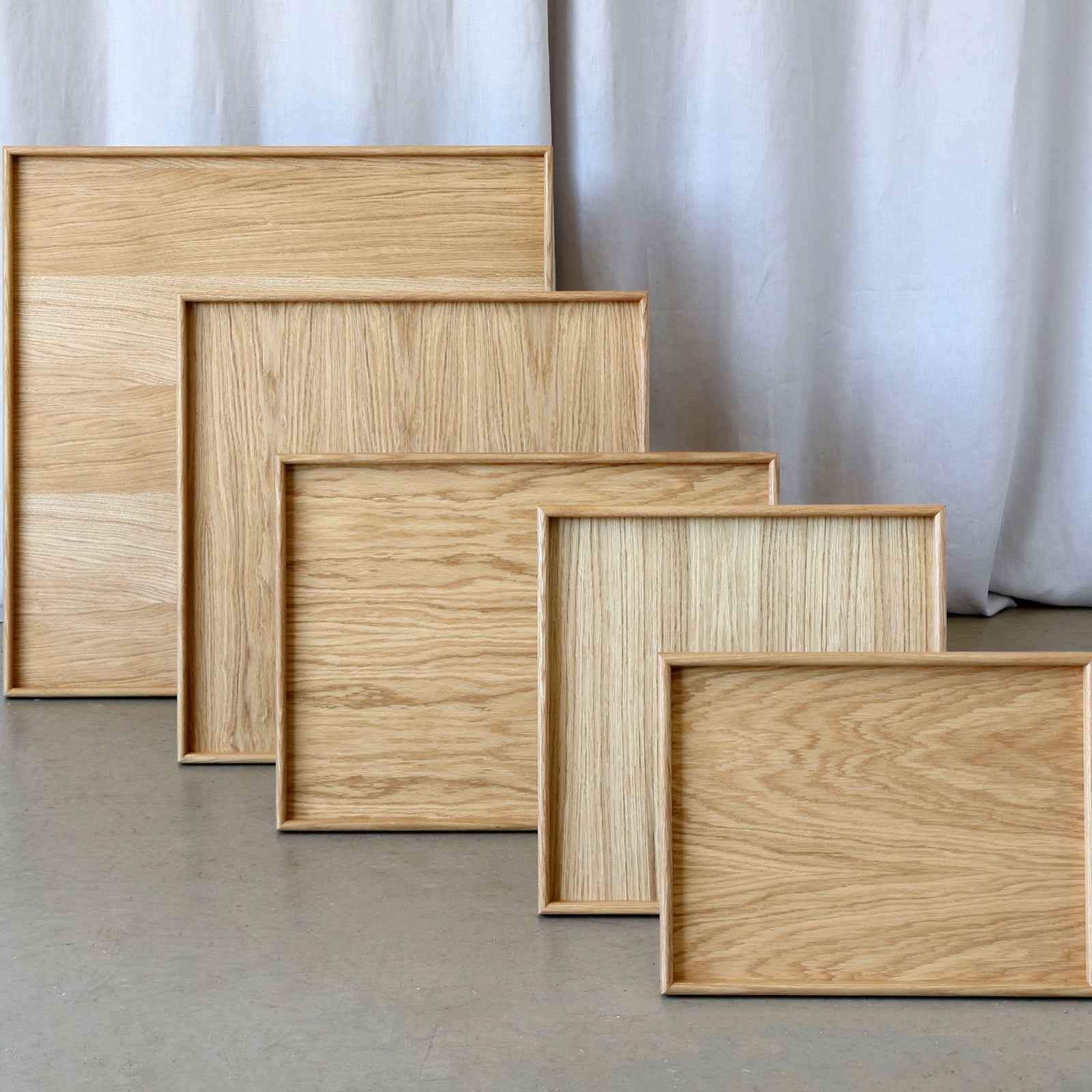 A set of handcrafted trays in various sizes, made from oak wood, perfect as a wooden tray for footstool or a coffee table tray.