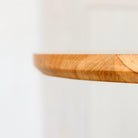 Close-up image highlighting the chamfered bottom edge of the table top.