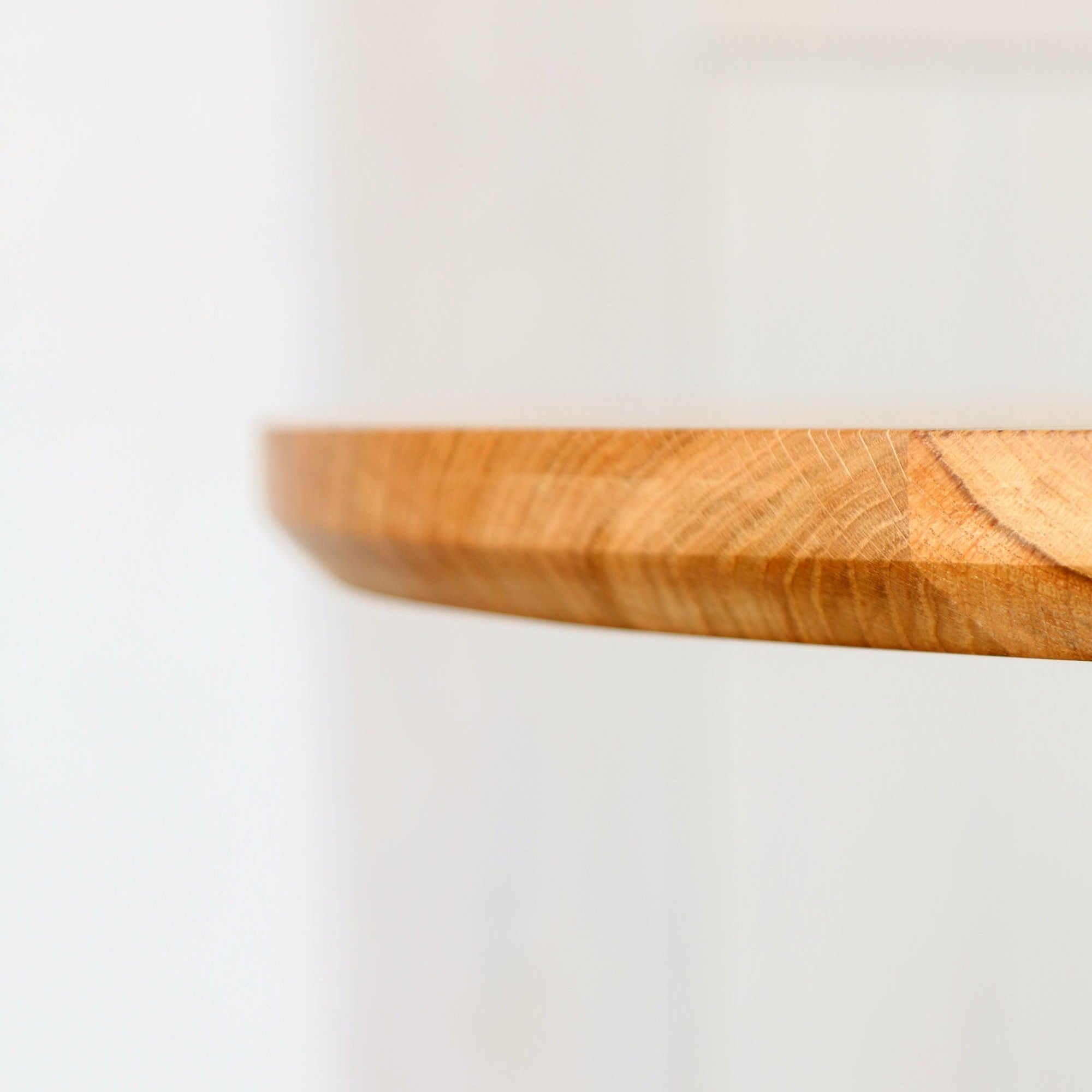 Close-up image highlighting the chamfered bottom edge of the table top.