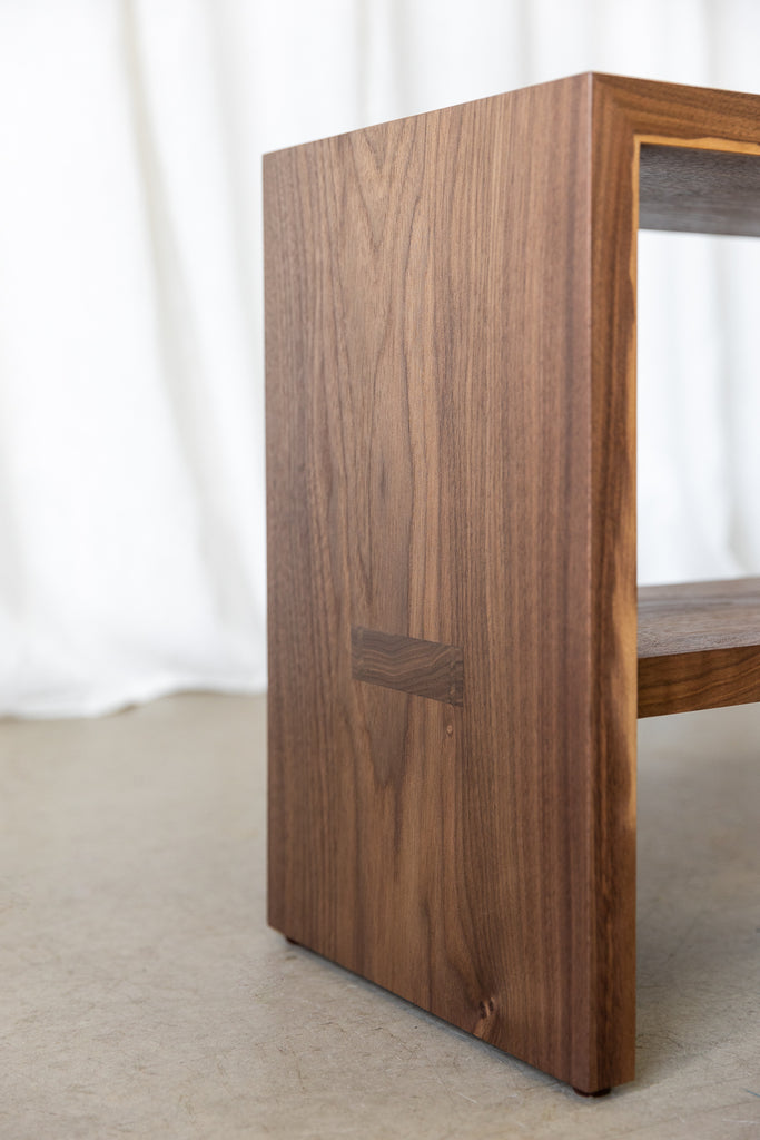 Close-up view of the side of a wooden bench, featuring the shelf's mortise and tenon joinery meticulously crafted for enhanced strength and longevity, exemplifying the commitment to quality craftsmanship and enduring design.