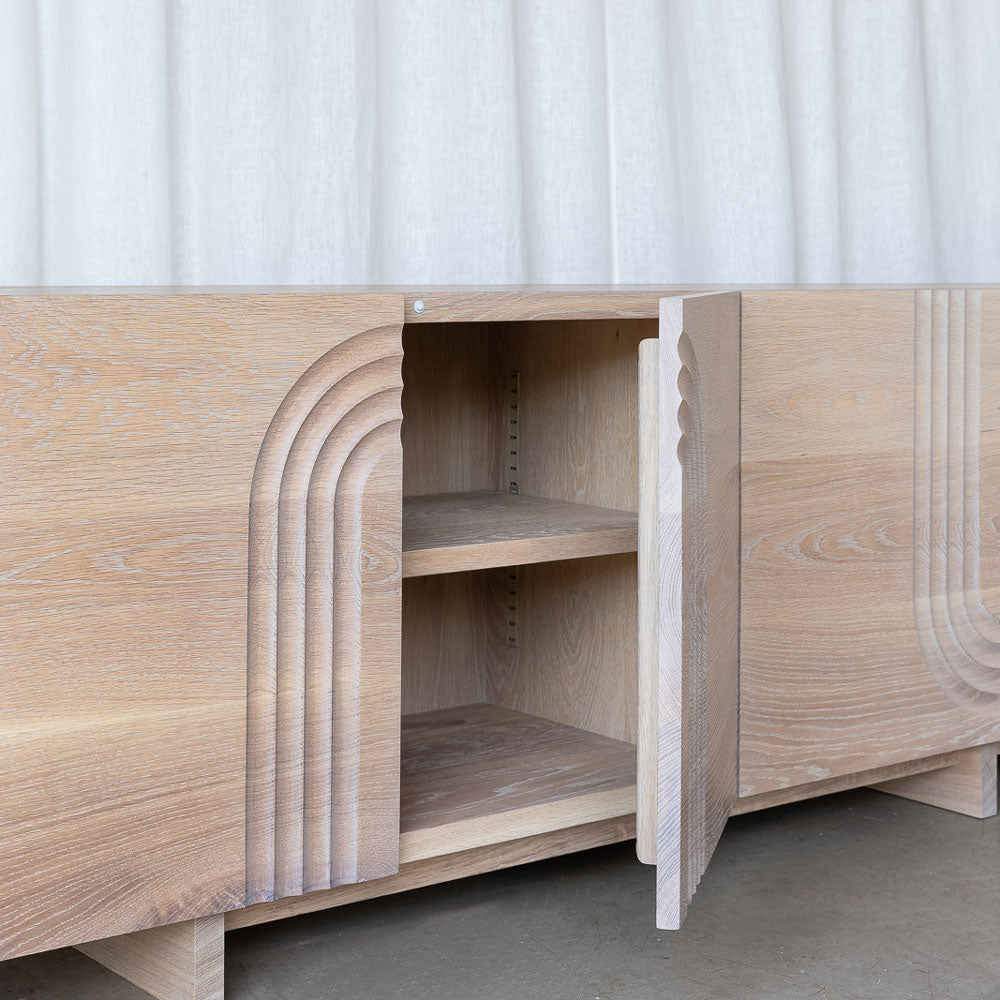 close-up view of the oak sideboard cupboard, showing hardware of the adjustable shelf