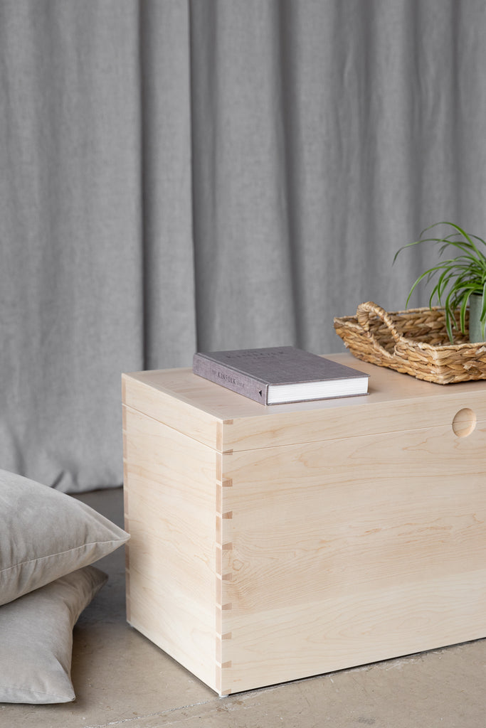 Styled image presenting the storage chest as an ideal ottoman coffee table solution, blending functionality with aesthetics for versatile living space.