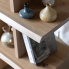 Close-up of the bookcase, styled with vases and books