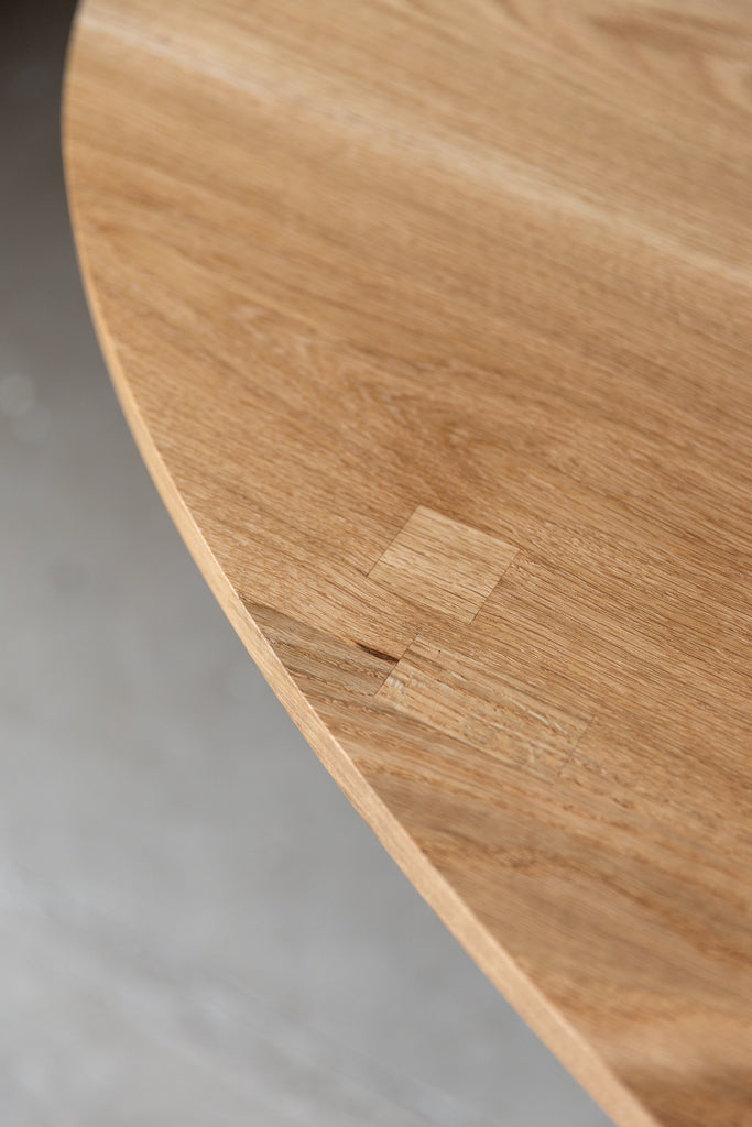 Close-up image highlighting the intricate hand-chiselled wooden blockings adorning the table's top, meticulously preserving the natural cracks and blemishes of the timber, enhancing its organic beauty and unique character.
