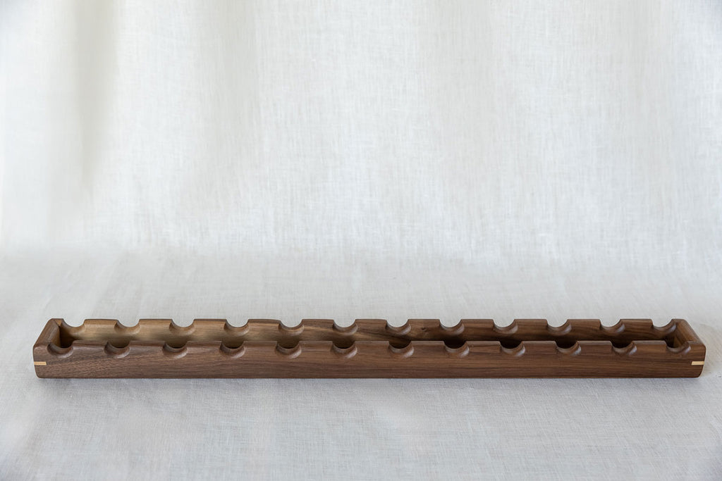 long and narrow canapé serving platter in walnut wood for 12 oval-shaped nibbles.