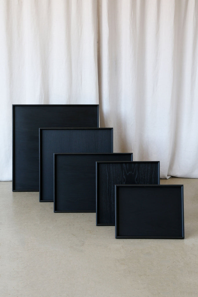 Five standard-size black wooden ottoman trays by Martelo and Mo