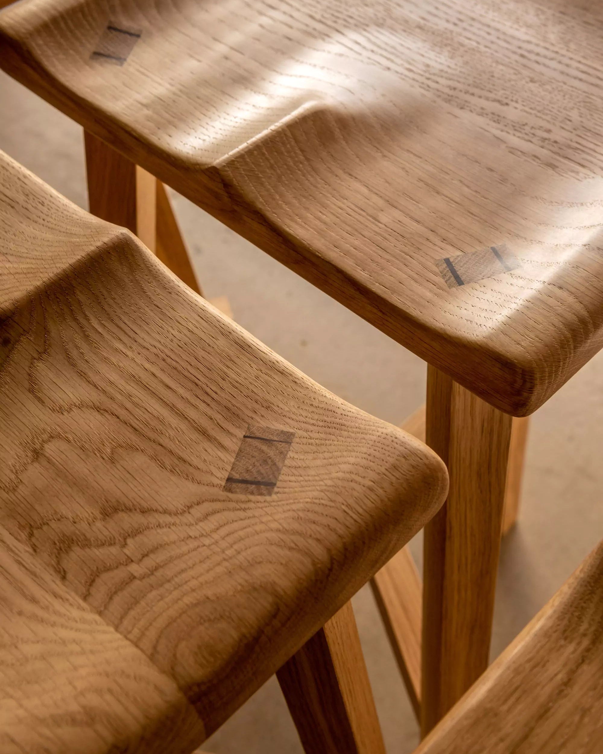 Wooden Oak stools with a soft light  on a neutral background