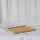 A close-up of a handcrafted tray, highlighting its elegant oak wood grain and precise craftsmanship, ideal as a coffee table tray.