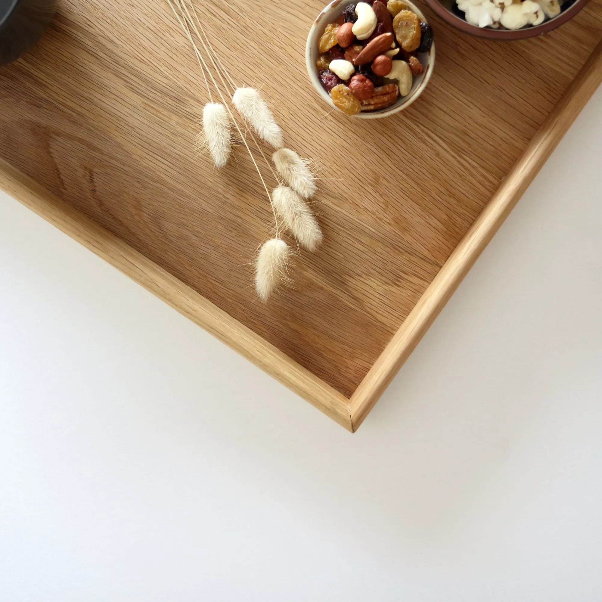 A close-up of a handcrafted tray, highlighting its elegant oak wood grain and precise craftsmanship, ideal as a coffee table tray.