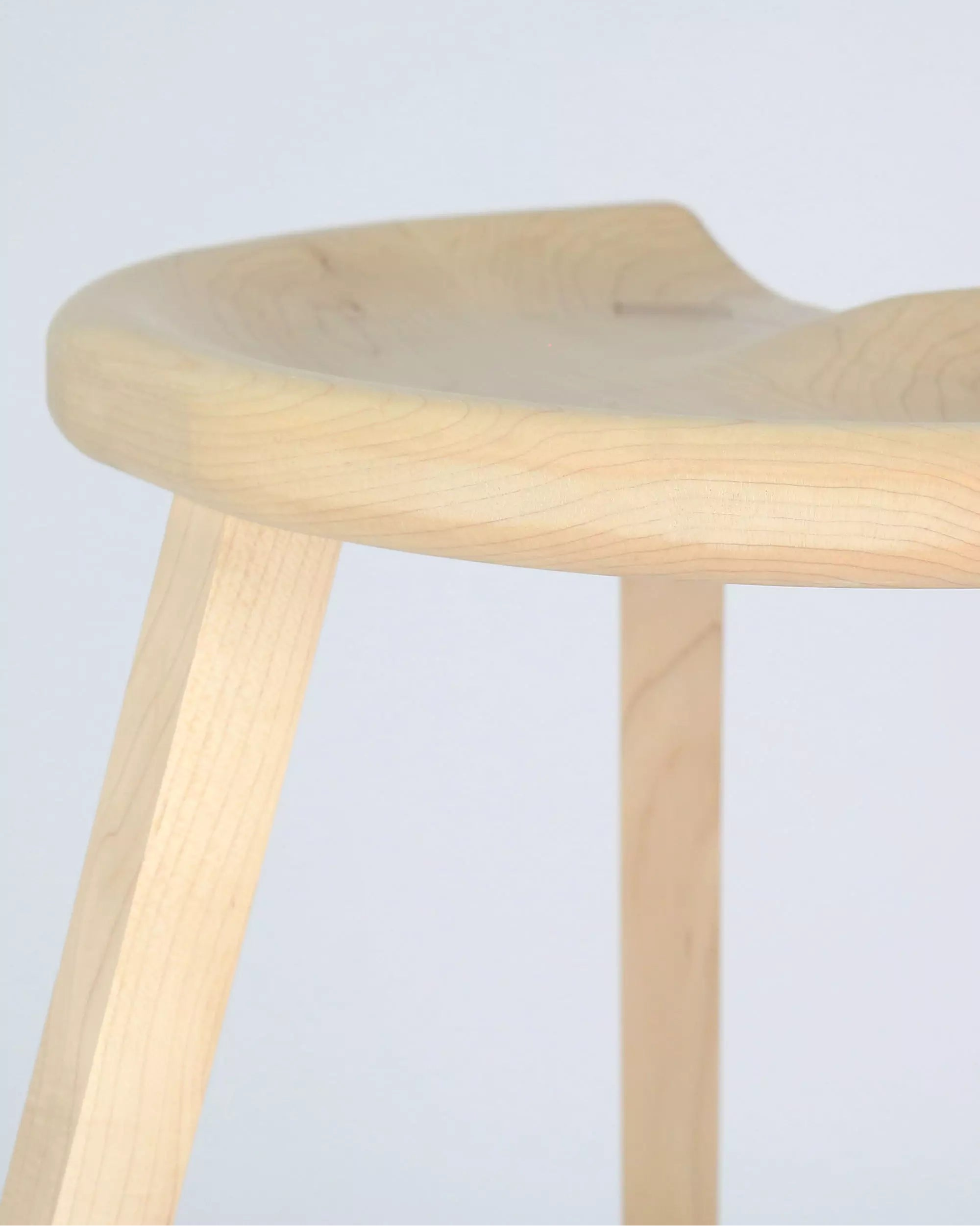 Maple stool with a light finish on a white background