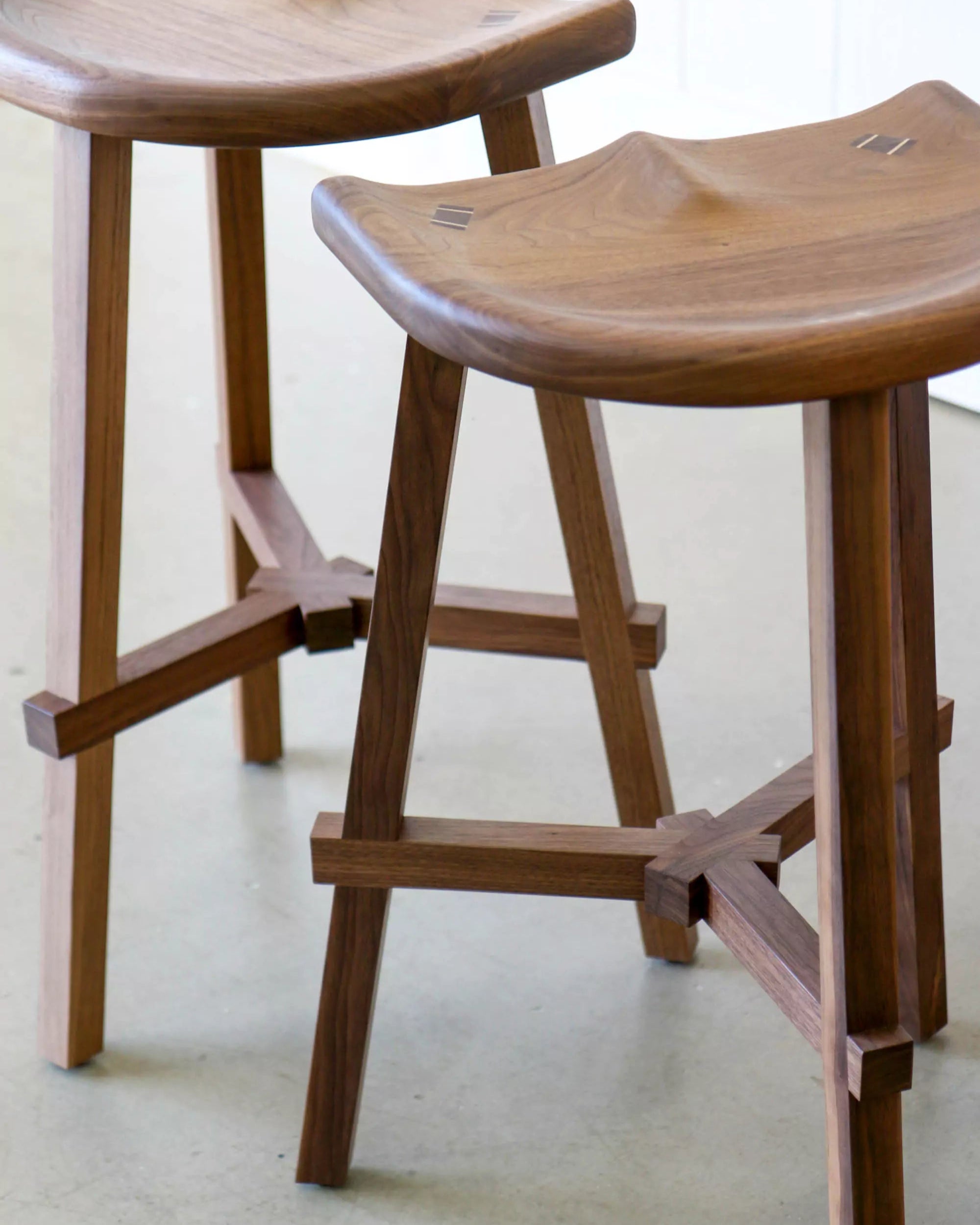 Wooden stools with a minimalist design on a light background