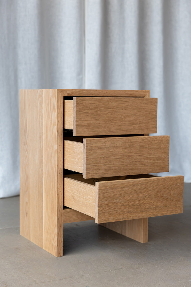 image of the oak Gaia bedside drawers showing all drawers half opened