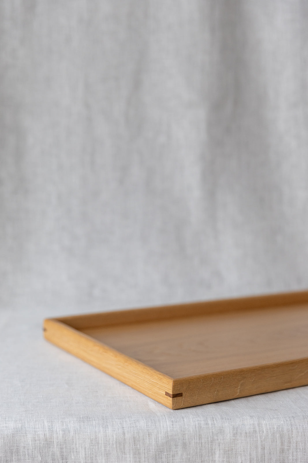 close-up image of the oak ottoman tray corner showing contrasting corner joinery