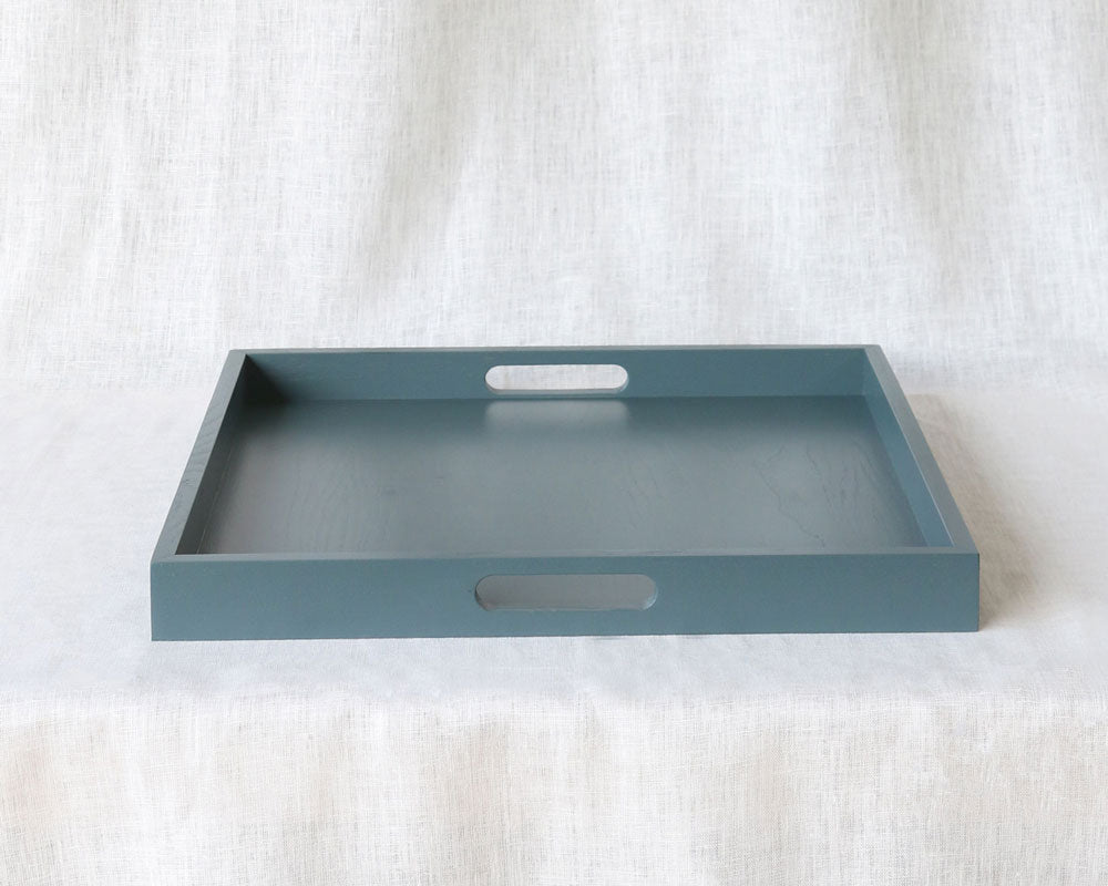 Front-facing image of the tray highlighting clean edges and dual handles against a soft white background.