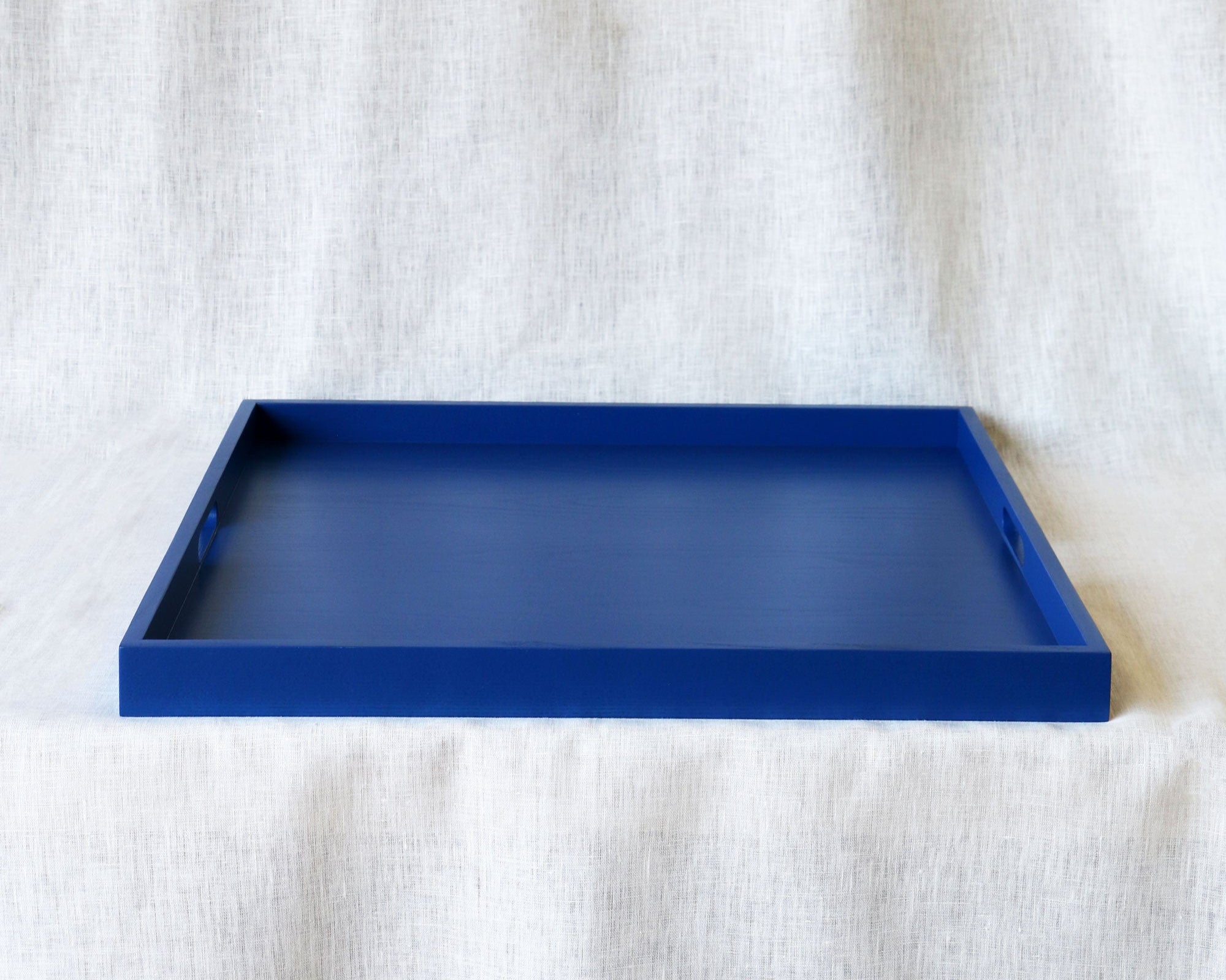 Blue tray on a textured white surface