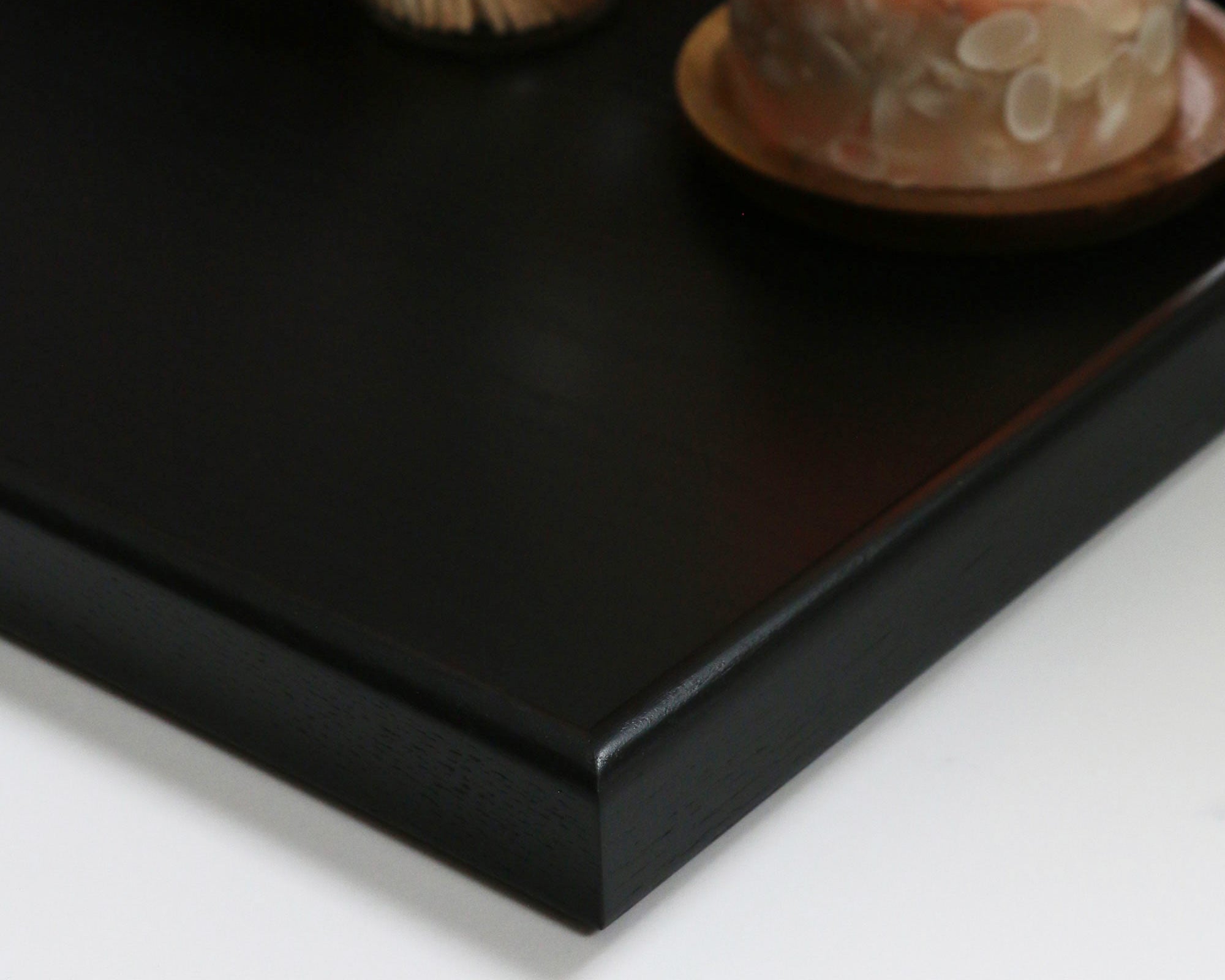 A detailed close-up of the smooth surface and fine joinery of a handcrafted tray, showcasing its premium quality.