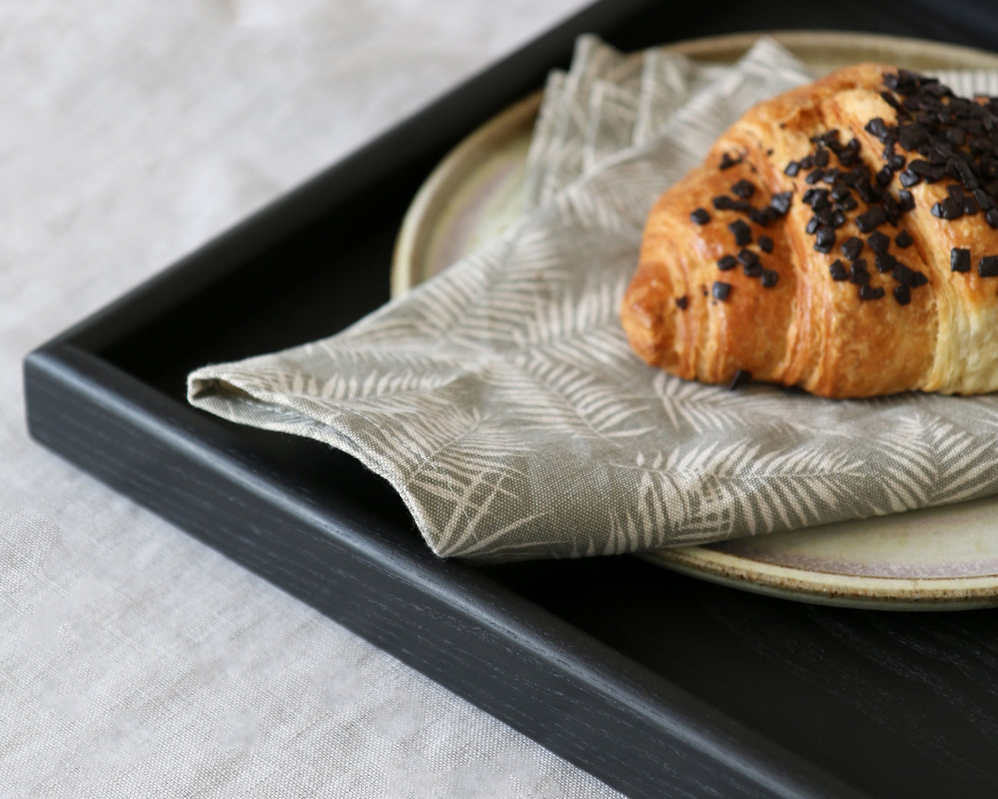 Close-up of a handcrafted tray, showcasing its rich wood grain with a warm black stain, perfect as a wooden tray for footstool or coffee table tray.