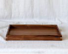 A large wooden footstool tray in walnut, featuring dovetail joinery and a finely polished surface.